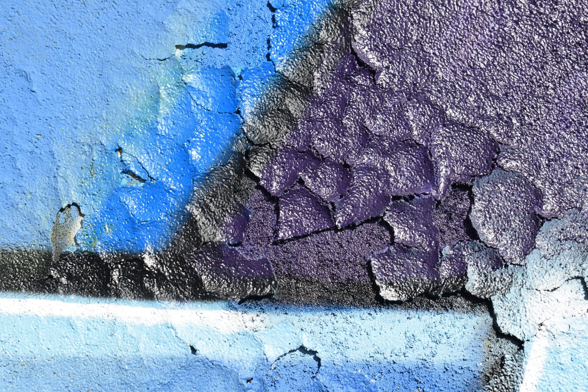 a close up of a blue and purple wall